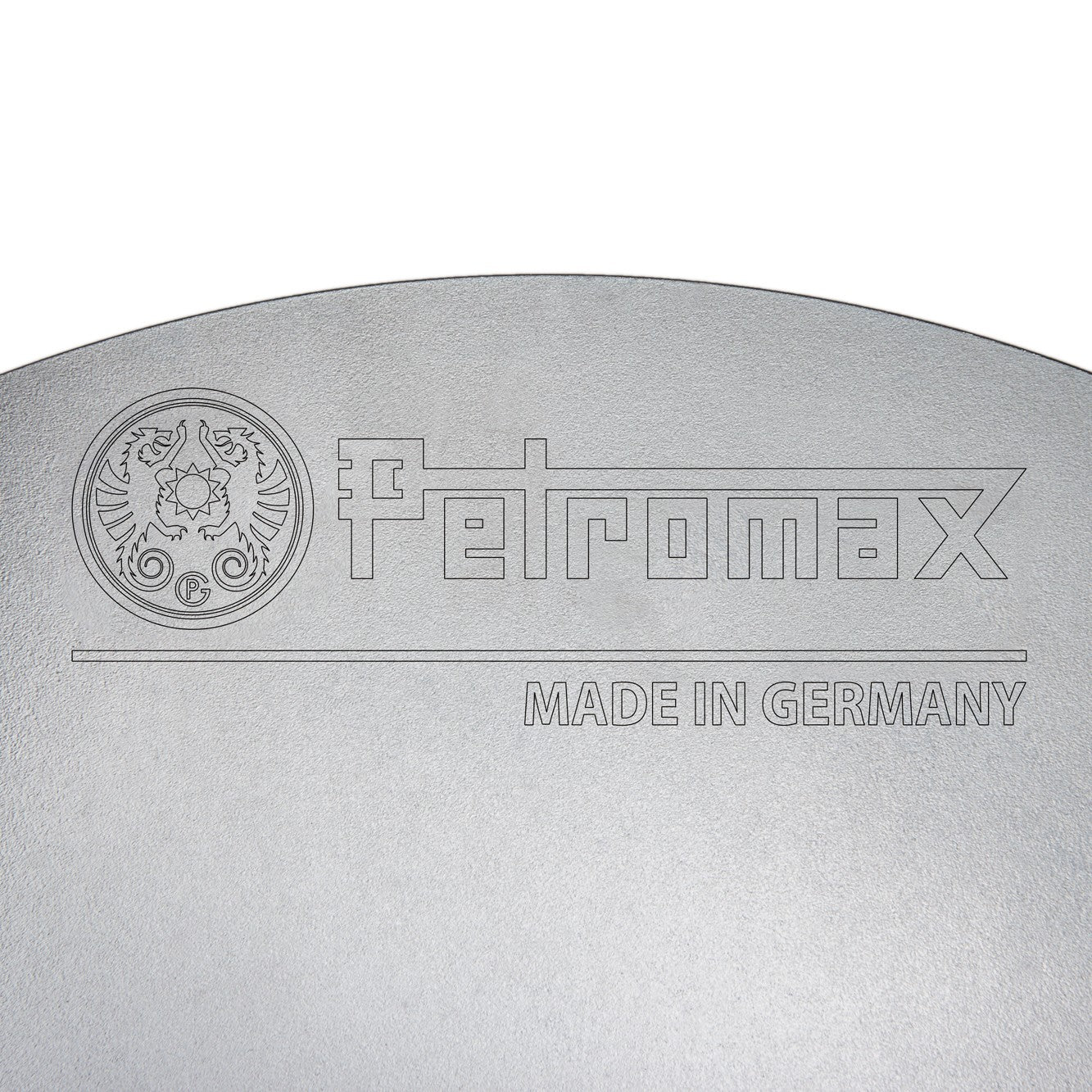 Close-up of a high-quality steel cooking surface featuring an engraved logo and "Made in Germany," highlighting durable craftsmanship for Farm, Garden & Tool, Camping, Best Sellers, Promo Eligible collections.