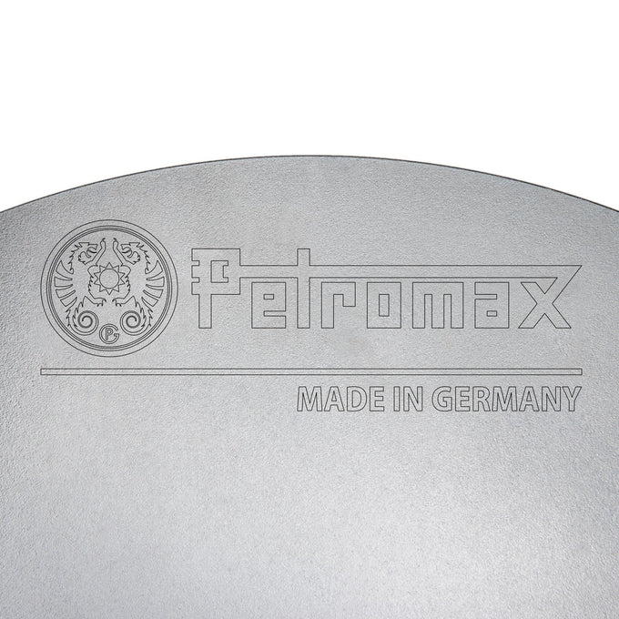 Close-up of a high-quality steel cooking surface featuring an engraved logo and "Made in Germany," highlighting durable craftsmanship for Farm, Garden & Tool, Camping, Best Sellers, Promo Eligible collections.