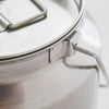 Close-up of a seamless small stainless steel milk can with sturdy handle and secure lid, crafted from shining 304 grade steel, ideal for farm, garden, and animal care use.