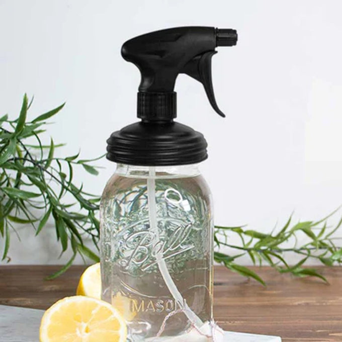 Black no-break plastic sprayer lid with adjustable nozzle on a clear regular-mouth mason jar, styled with lemon halves and green herbs, featured in Home & Decor, Household Helpers, USA Made collections.
