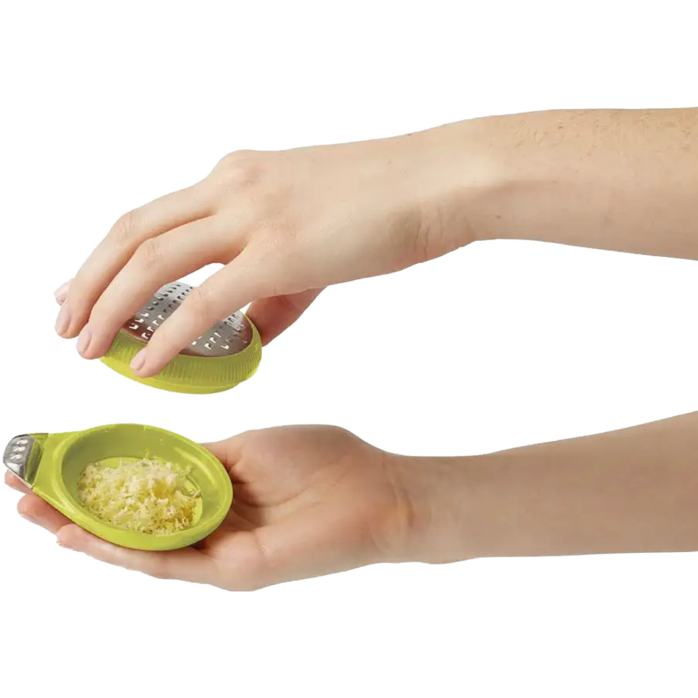 Hands holding a lime-green ergonomic citrus zester with stainless steel blade and channel knife, showcasing freshly grated zest for Kitchen & Food, Cooking Helpers, and Best Sellers collections.