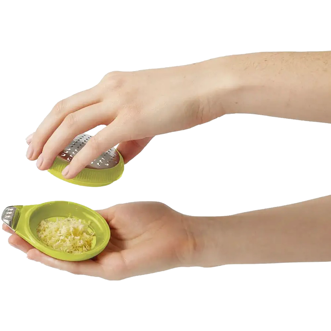 Hands holding a lime-green ergonomic citrus zester with stainless steel blade and channel knife, showcasing freshly grated zest for Kitchen & Food, Cooking Helpers, and Best Sellers collections.