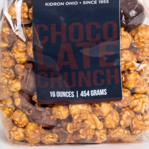 Clear bag of handcrafted caramel popcorn with rich chocolate crunch pieces, a unique sweet and crunchy snack made in USA, featured in Kitchen & Food, Snacks and Sweets, Popcorn, USA Made, and Best Sellers collections.