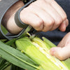 Hand using a sturdy galvanized steel single-hook cornhusker with leather palm pad and double wrist strap to remove husks from fresh corn, part of Farm, Garden & Tool, Farm Tools, USA Made, Best Sellers collections.