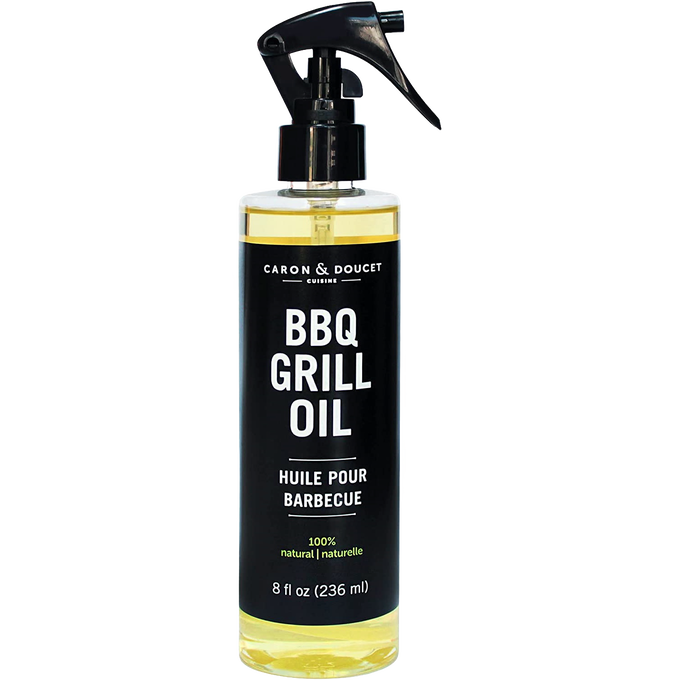 Clear spray bottle of natural BBQ grill oil with black label and trigger nozzle, designed for household cleaning and grilling use in home and decor collections.