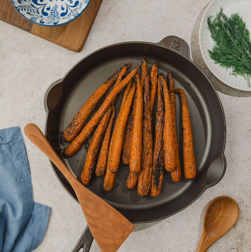 Handcrafted lightweight cast iron skillet with roasted carrots, featuring a smooth cooking surface marked size 12, suited for Farm, Garden & Tool, Kitchen & Food, Camping, Cookware, Cast Iron, USA Made, and Best Sellers collections.