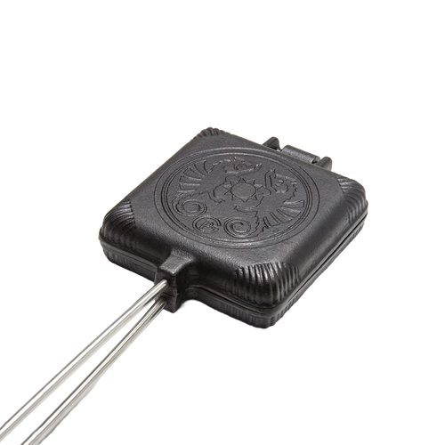 Cast iron sandwich iron with a hinged design and decorative embossed lid, suited for toasting sandwiches over campfires, featured in Farm, Garden & Tool and Camping collections.