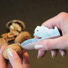 Handheld walnut cracker in stainless steel with a playful squirrel shape, demonstrating ease of cracking walnuts by prying shells apart, ideal for Kitchen & Food and Food Prep collections.