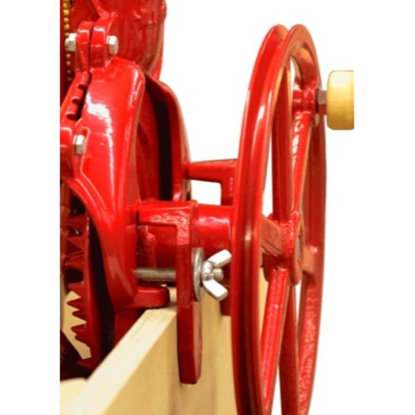 Close-up of the handcrafted cast iron corn sheller in bright red with a wooden handle on the flywheel, part of Farm, Garden & Tool, Farm Tools, and Best Sellers collections.