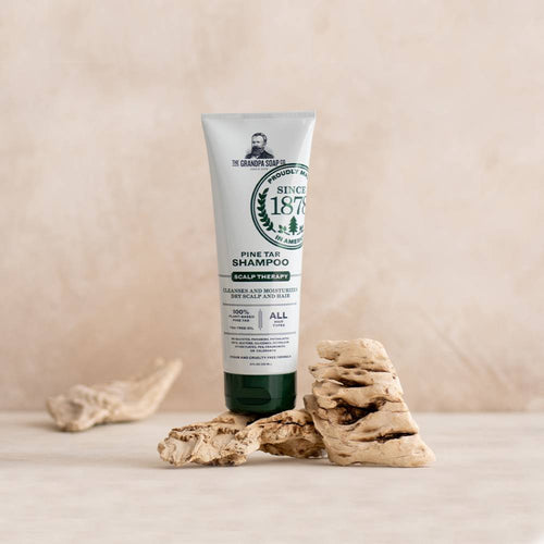 Handcrafted tube of pine tar shampoo with tea tree oil for deep cleansing and moisturizing dry scalp, made in USA, featured in Health & Wellness and Grooming collections.
