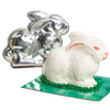 Shiny two-piece metal bunny cake pan alongside a decorated white bunny cake with orange accents, ideal for festive baking in Kitchen & Food, Cookware, USA Made, and Best Sellers collections.