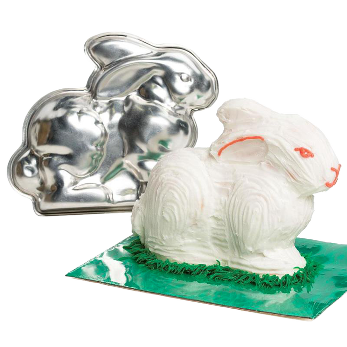 Shiny two-piece metal bunny cake pan alongside a decorated white bunny cake with orange accents, ideal for festive baking in Kitchen & Food, Cookware, USA Made, and Best Sellers collections.