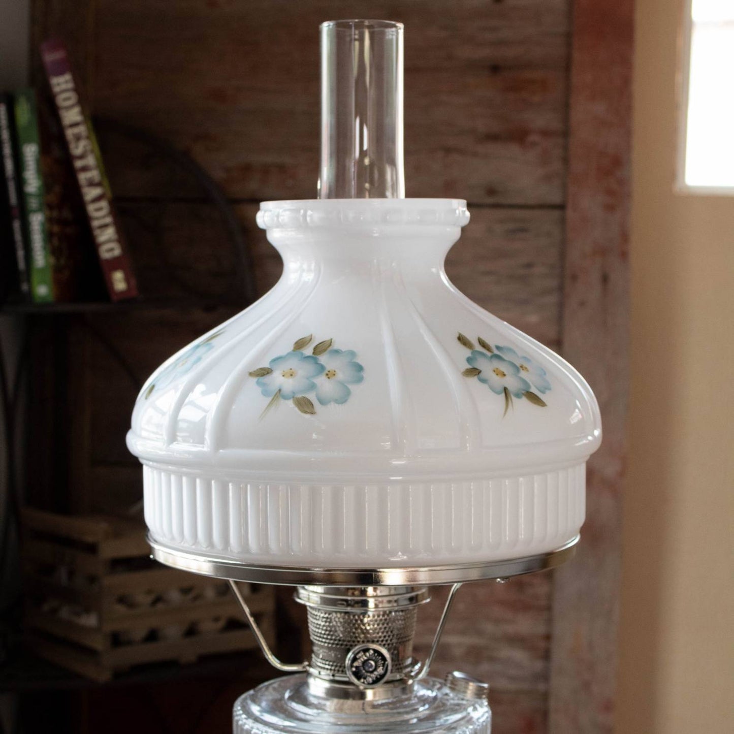 Handcrafted white glass oil lamp shade decorated with delicate blue dogwood flowers and green leaves, compatible with Aladdin lamps, found in Lamps & Lighting and Best Sellers collections.
