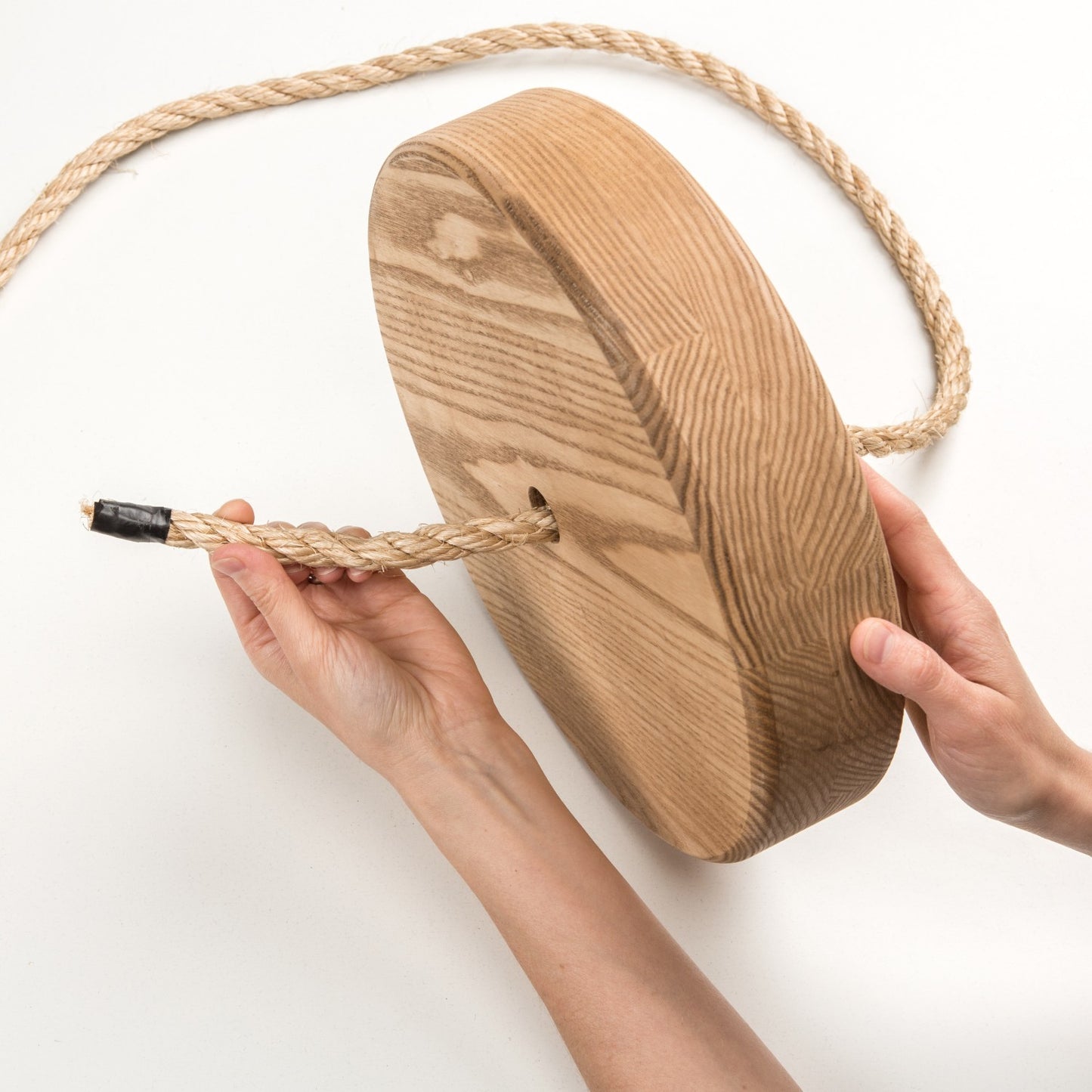 Handcrafted round wooden swing seat made in USA with sturdy natural rope, designed for outdoor play and children's fun, featured in Toys, Books & Games and Best Sellers collections.