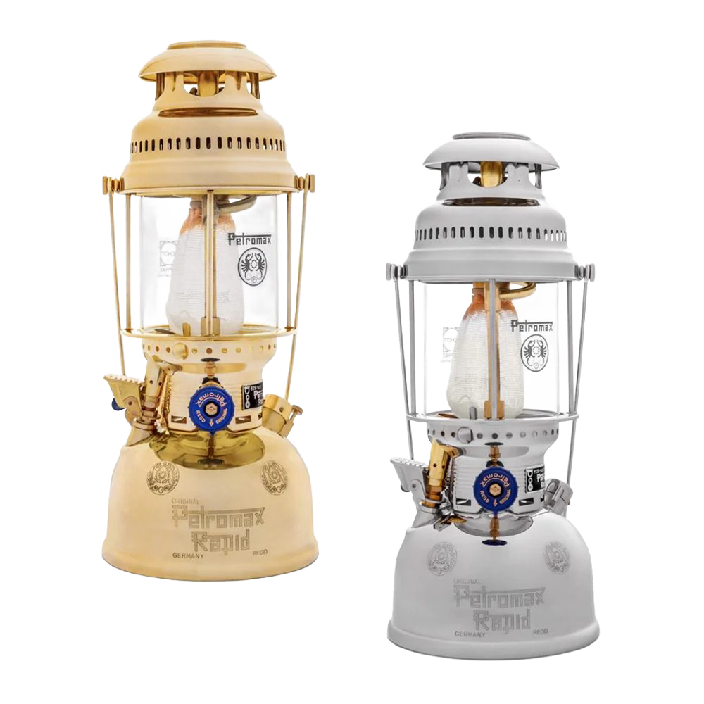 Two classic kerosene pressure lamps in beige and white finishes, featuring glass chimneys and brass details, designed for durable outdoor lighting in camping and emergency supplies collections.