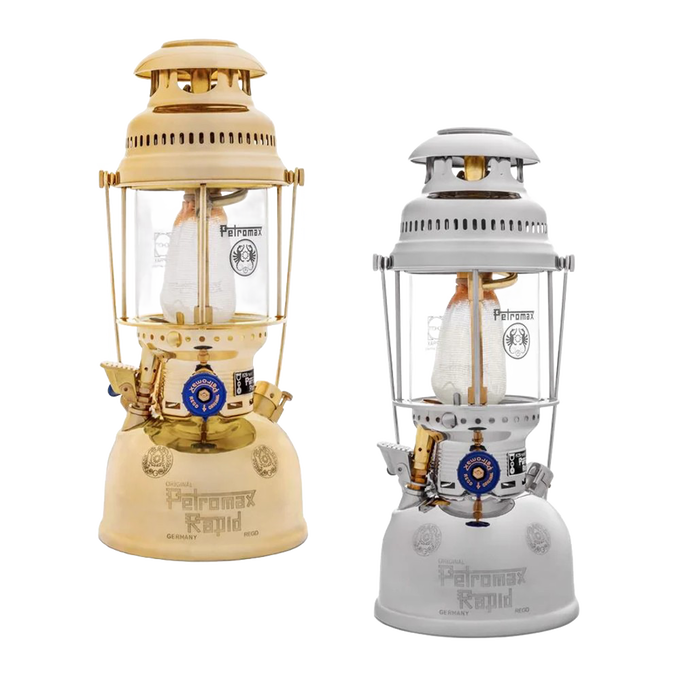 Two classic kerosene pressure lamps in beige and white finishes, featuring glass chimneys and brass details, designed for durable outdoor lighting in camping and emergency supplies collections.