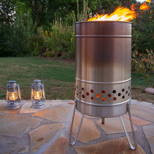 Outdoor fire barrel made of durable metal with perforated air vents and sturdy legs, glowing warmly in a garden setting, ideal for Farm, Garden & Tool, Camping, and Best Sellers collections.