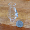 Clear handcrafted glass oil lamp chimney with 3/4" base, shown next to a quarter for scale, suitable for lamps and lighting, parts and accessories, and chimneys and globes collections.