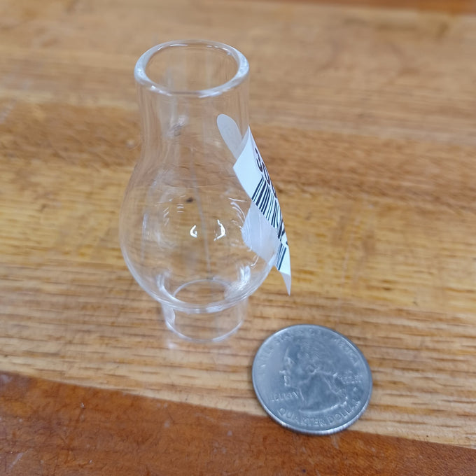Clear handcrafted glass oil lamp chimney with 3/4" base, shown next to a quarter for scale, suitable for lamps and lighting, parts and accessories, and chimneys and globes collections.