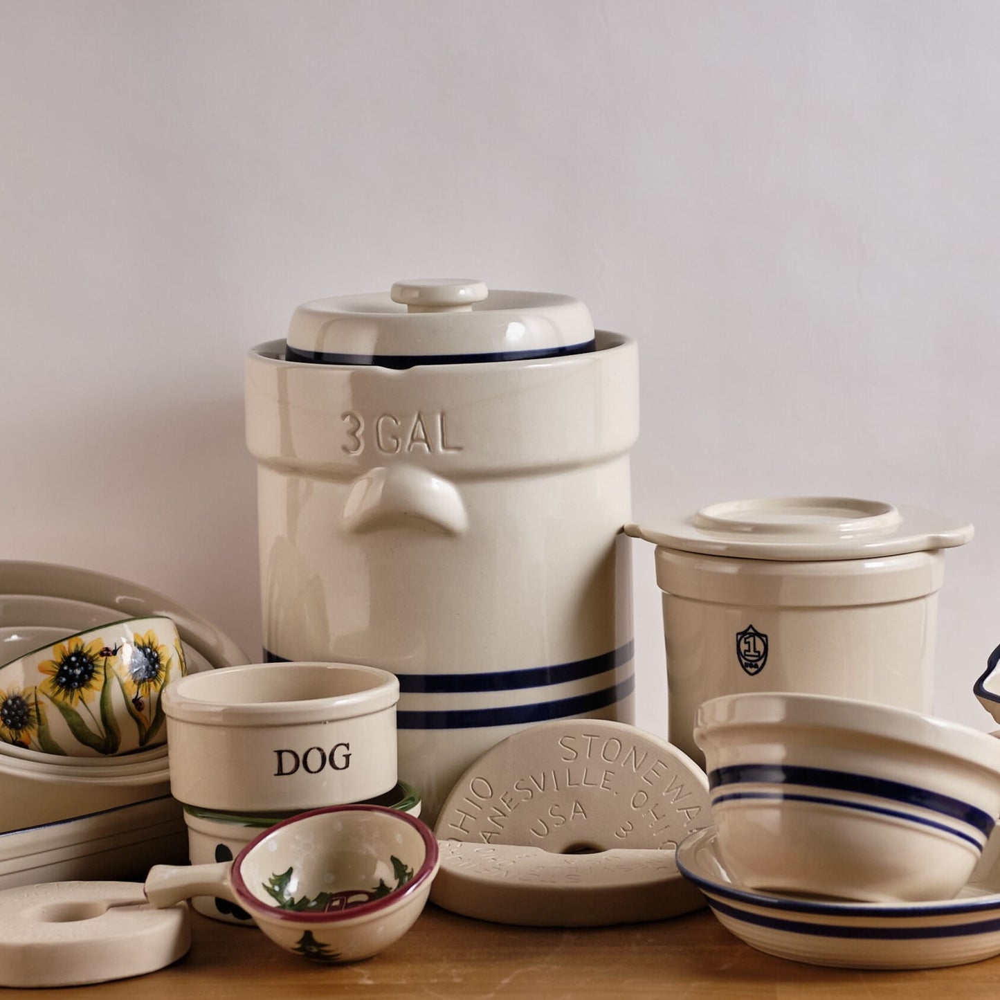 Handcrafted cream stoneware cover with side handles and a raised center, made in USA, perfect for protecting fermenting food in kitchen and food preservation collections.