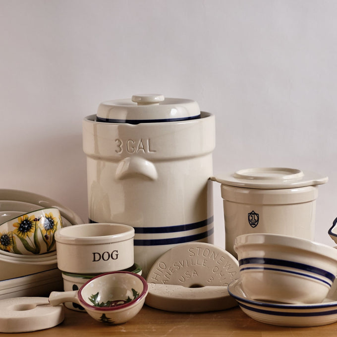 Handcrafted cream stoneware cover with side handles and a raised center, made in USA, perfect for protecting fermenting food in kitchen and food preservation collections.