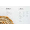 Open cookbook showing the table of contents for sourdough bread recipes and techniques, accompanied by a rustic loaf, suitable for Books, Cookbooks, and Home and Garden How-To Books collections.