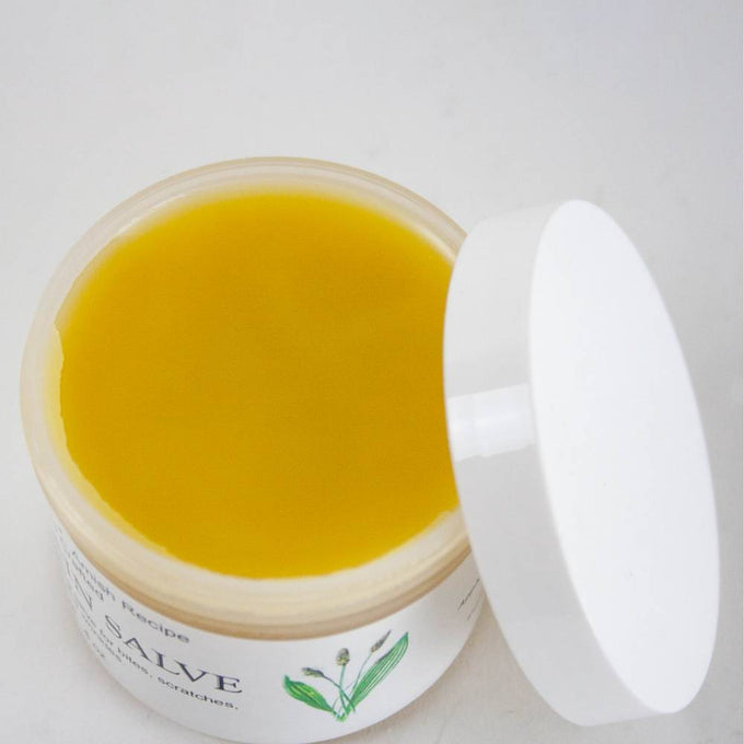 Open jar of handcrafted Amish made all-natural plantain salve with smooth yellow ointment, featured in Health & Wellness, Health Remedies, USA Made, and Best Sellers collections.