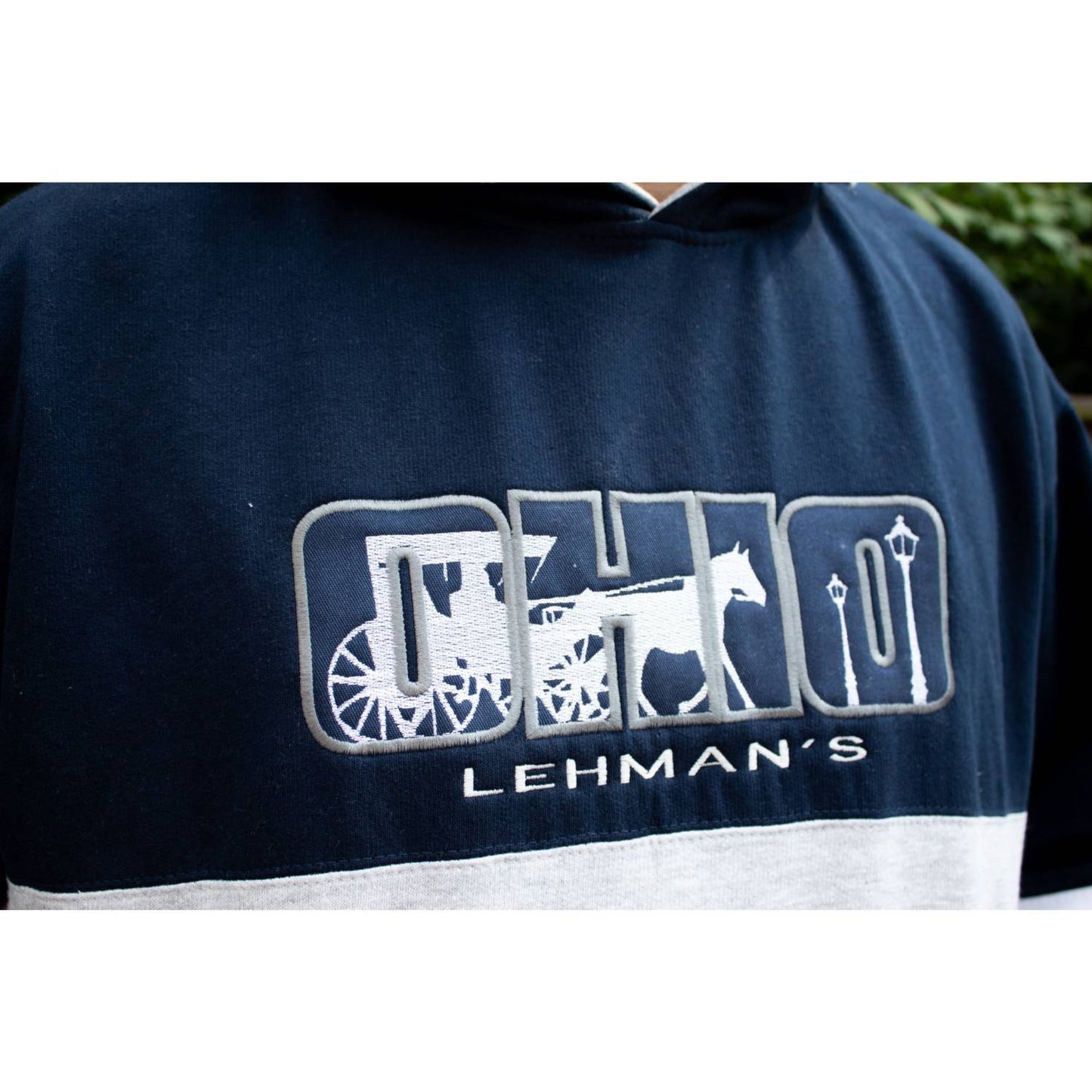 Close-up of a handcrafted fleece hoodie sweatshirt with an embroidered Ohio design featuring a horse and carriage, color blocking, and Lehman’s branding, ideal for Health & Wellness and Clothing and Accessories collections.