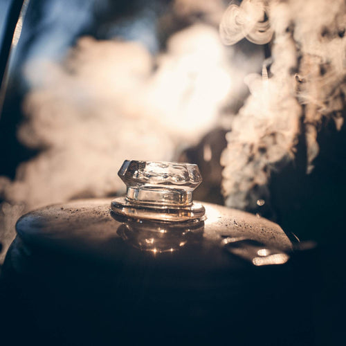 Clear replacement glass knob atop a steaming metal percolator lid, designed for Kitchen & Food, Brewing Coffee and Tea, Best Sellers, and Promo Eligible collections, showcasing craftsmanship.