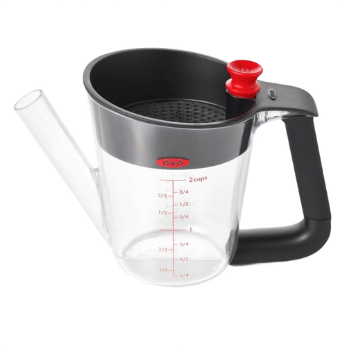 Clear fat separator with black soft-grip handle, red stopper, measurement markings, and built-in strainer, designed for Kitchen & Food, Cooking Helpers, and Promo Eligible collections.