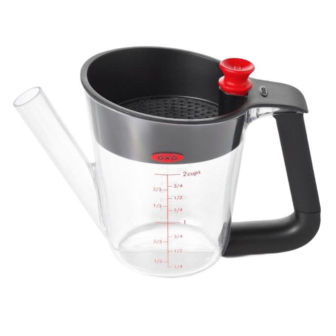 Clear fat separator with black soft-grip handle, red stopper, measurement markings, and built-in strainer, designed for Kitchen & Food, Cooking Helpers, and Promo Eligible collections.
