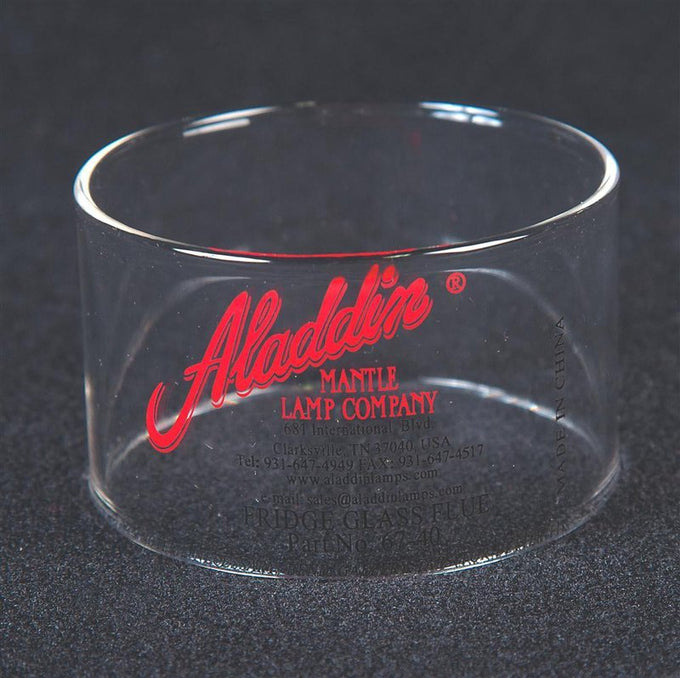 Clear cylindrical glass chimney with red and black vintage-style Aladdin Mantle Lamp Company branding, suitable for appliance and heating collections.