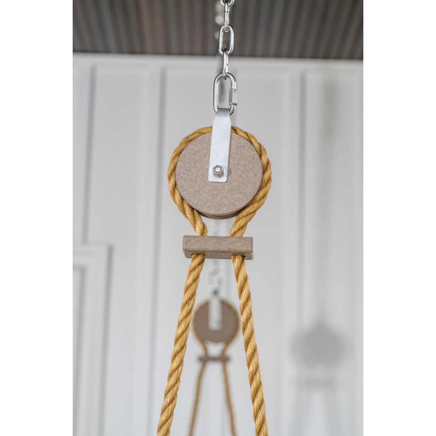 Close-up of a handcrafted rope and pulley system with metal chain and wooden components, designed for smooth, quiet swinging, made in USA, featured in Home & Decor, Outdoor Furniture, Best Sellers, and Promo Eligible collections.