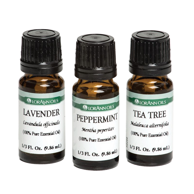 Three amber glass bottles with black caps containing 100% pure essential oils in lavender, peppermint, and tea tree scents, crafted for Health & Wellness collections.