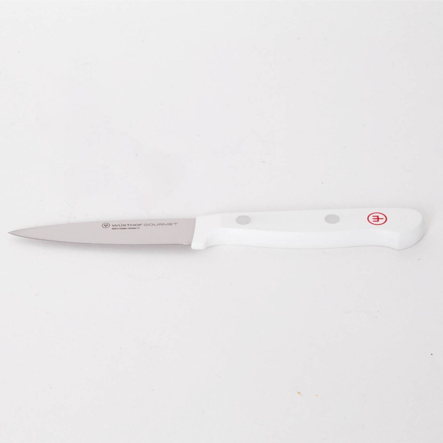 Slim paring knife with a sharp stainless steel blade and ergonomic white handle featuring rivet accents, designed for precision food prep in Kitchen & Food and Food Prep collections.