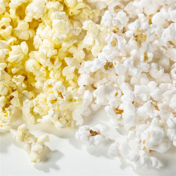 Close-up of freshly popped microwave popcorn with visible butter coating on some pieces, showcasing an inviting snack made in USA, featured in Kitchen & Food, Snacks and Sweets, Popcorn collections.