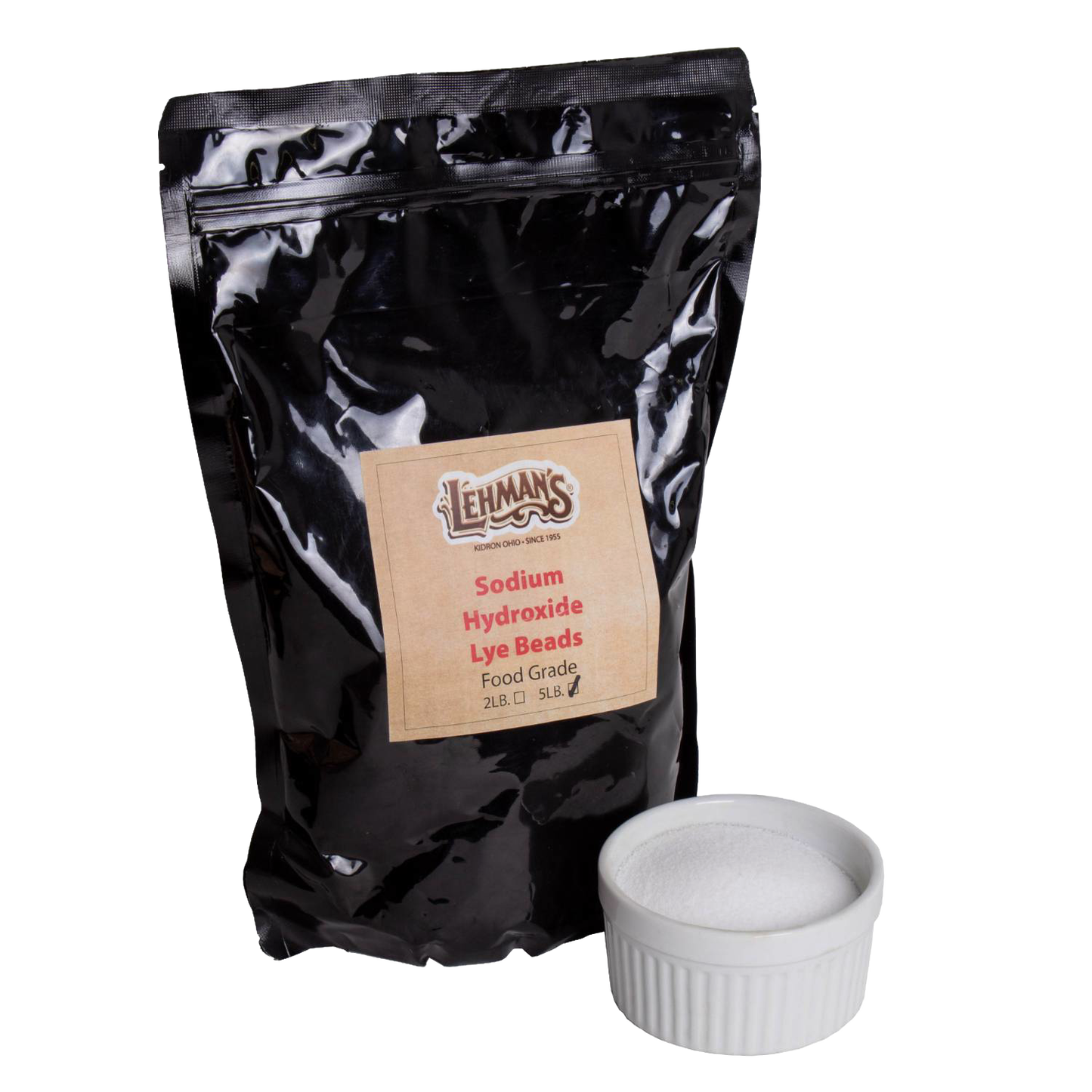 Glossy black resealable pouch labeled for food-grade sodium hydroxide lye beads in 2-lb or 5-lb sizes, paired with a white ceramic ramekin filled with fine white beads, featured in USA Made and Soapmaking Supplies collections.