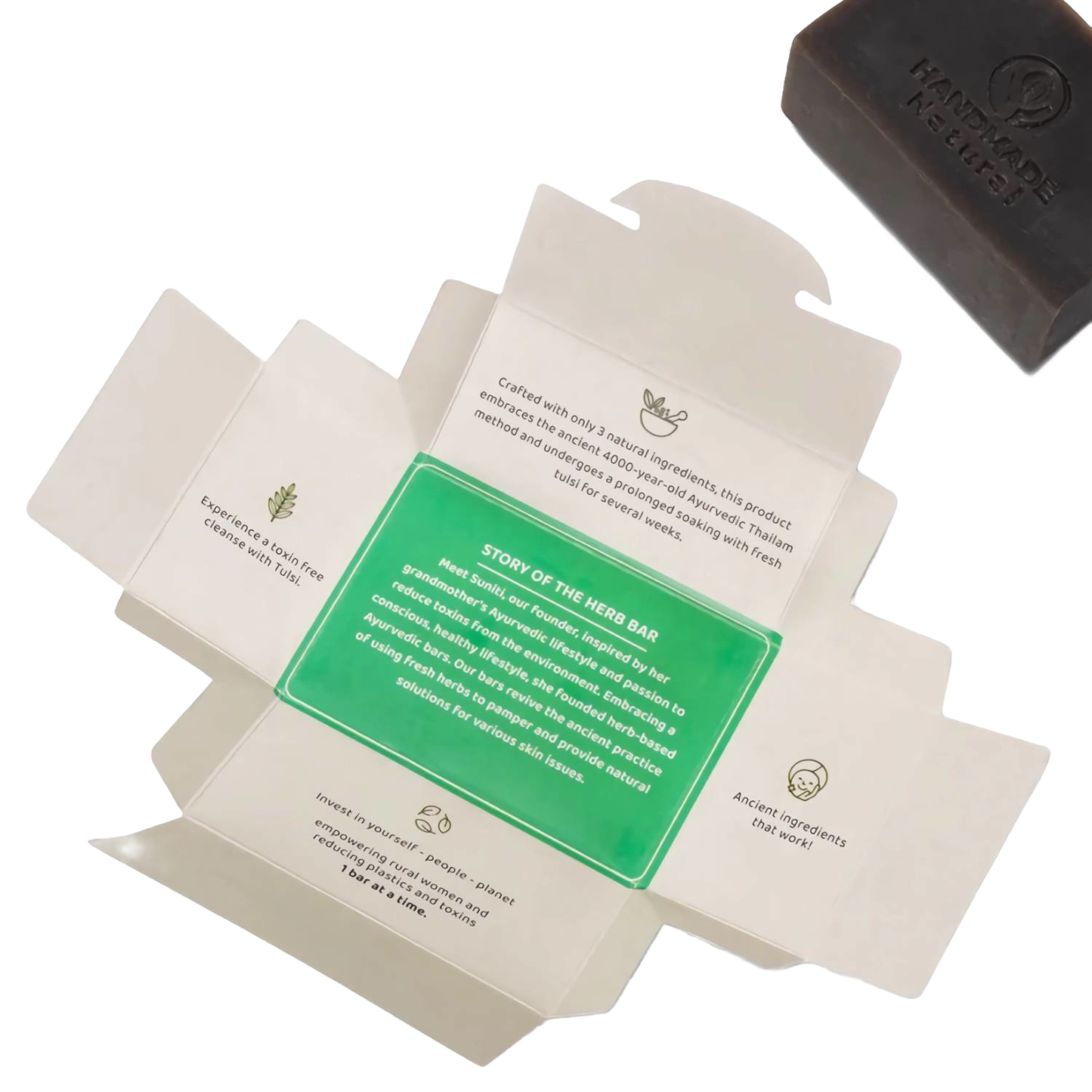 Opened packaging displaying the story and benefits of the handcrafted Tulsi Clarifying Ayurvedic Bar Soap with a dark brown bar featuring a “Handmade” impression, ideal for health and wellness and soapmaking collections.