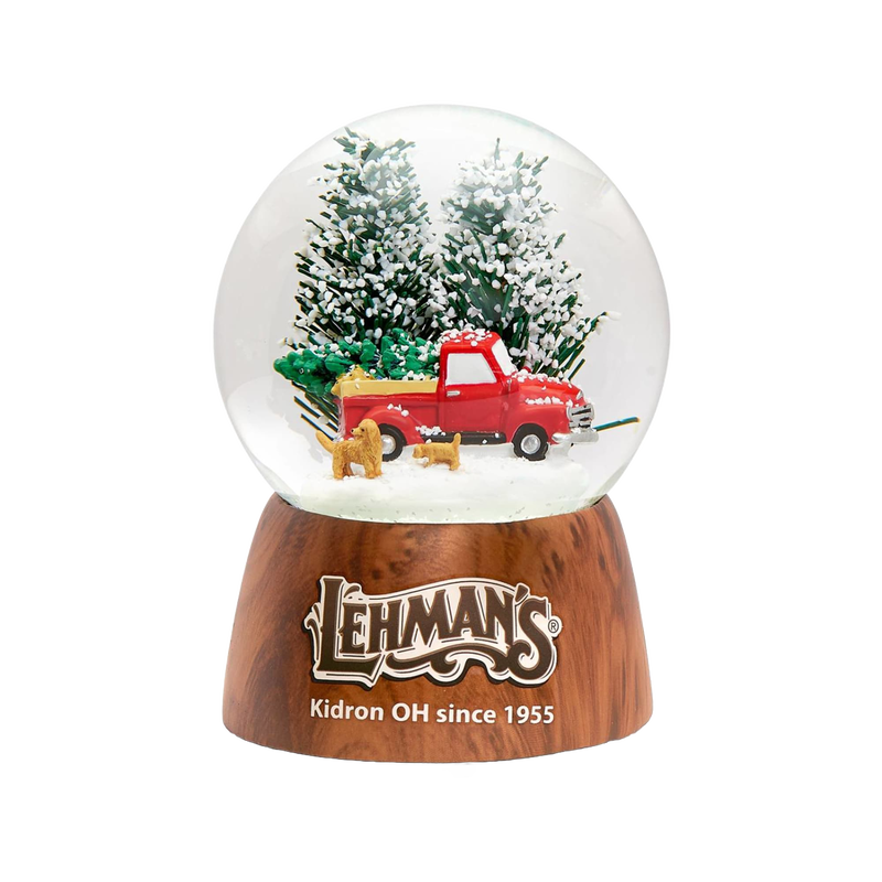 Handcrafted musical snow globe featuring a red vintage truck with a Christmas tree and two dogs, set among snowy pine trees, perfect for Home & Decor and Holiday Decor collections.