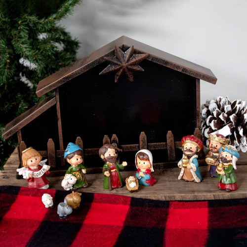 Eleven-piece nativity scene with small, colorful figurines including baby Jesus, Mary, Joseph, three Magi, an angel, farm animals, and a rustic metal creche, ideal for holiday decor and home display.