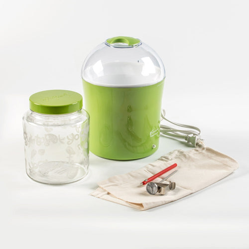 Green electric yogurt and Greek yogurt maker with clear dome lid, accompanied by a decorative glass jar with green lid, measuring tools, and a cloth pouch, featured in Kitchen & Food and Specialty Equipment collections.