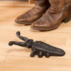 Black painted cast iron boot jack shaped like a cricket, designed to assist with easy boot removal, part of Home & Decor, Household Helpers, and Best Sellers collections.