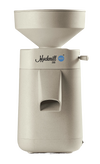 Electric stone grain mill in a smooth beige finish with a wide hopper and compact design, part of Kitchen & Food, Grain Mills, Best Sellers, and New collections.
