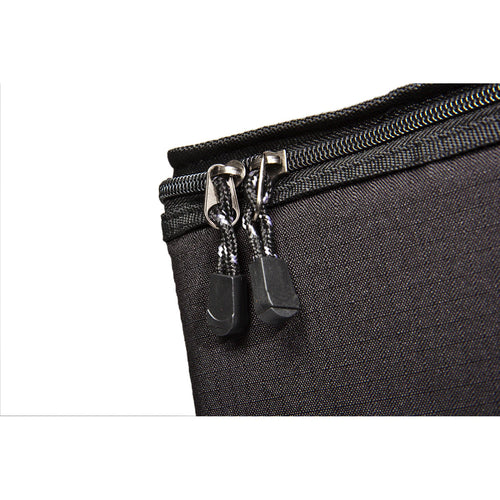 Close-up of durable black ripstop fabric with dual zipper pulls on a padded transport bag designed for secure storage and easy carrying, ideal for camping and outdoor use.