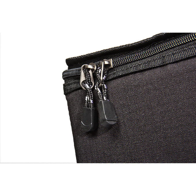 Close-up of durable black ripstop fabric with dual zipper pulls on a padded transport bag designed for secure storage and easy carrying, ideal for camping and outdoor use.