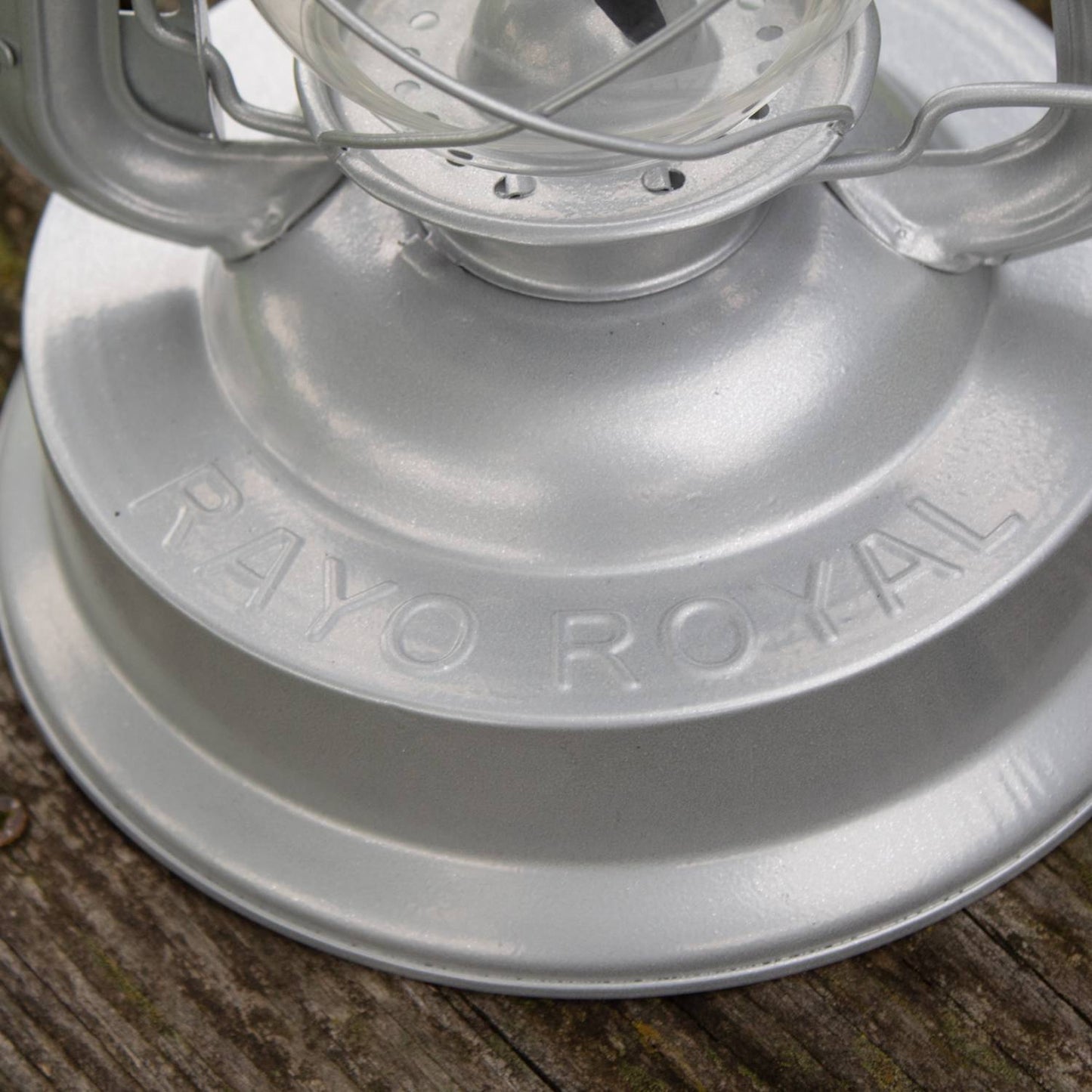 Close-up of a handcrafted silver metal lantern base embossed with "Rayo Royal," part of the Farm, Garden & Tool, Camping, and Emergency Supplies collections.