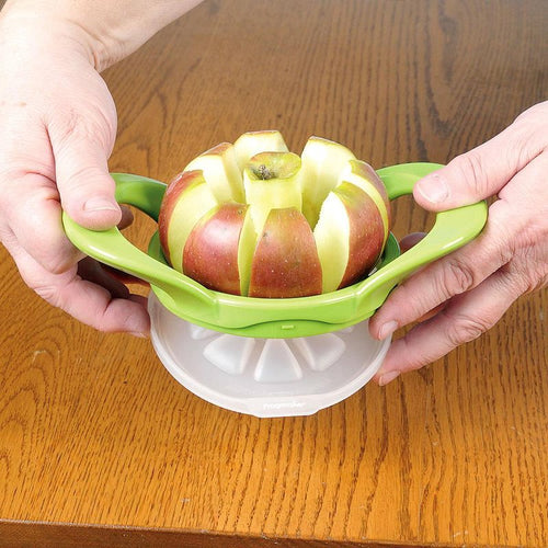 Hands pressing down on a green plastic apple cutter slicing an apple into eight wedges, designed for easy fruit preparation and featured in Kitchen & Food, Apple Harvest Supplies, and Best Sellers collections.