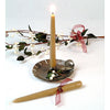 Handcrafted olive-colored bayberry taper candle burning in a rustic metal holder with decorative white berries and greenery, ideal for holiday decor and made in USA.