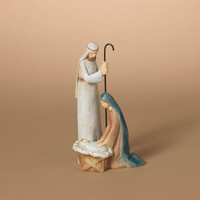 Handcrafted resin nativity figurine depicting the Holy Family with Joseph standing and Mary kneeling beside a manger, ideal for Home & Decor, Holiday Decor, Best Sellers, and Promo Eligible collections.