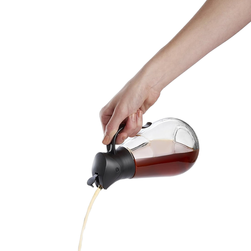 Clear glass syrup dispenser with black gravity lid pouring syrup smoothly, designed for easy storage and serving, featured in Kitchen & Food, Storage and Serving, and Best Sellers collections.